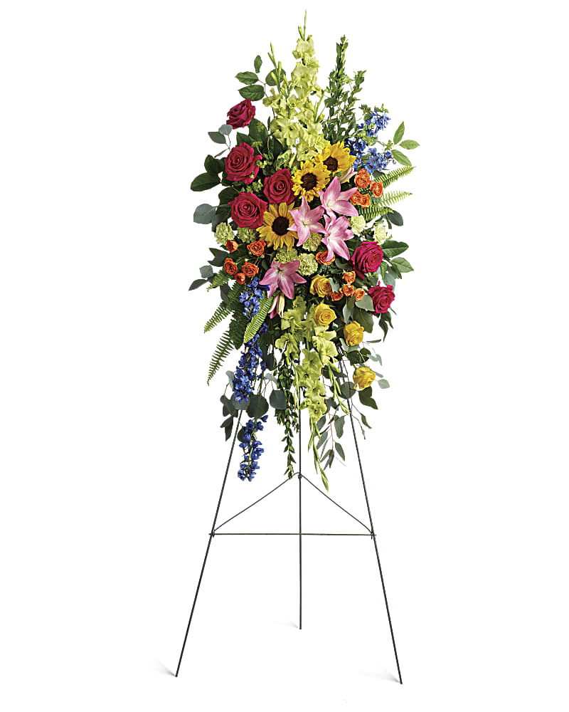 A standing spray of assorted bright colored flowers.  Flower variety will vary depending on availability. Arrangement will be as close as possible, but may not be exact. 