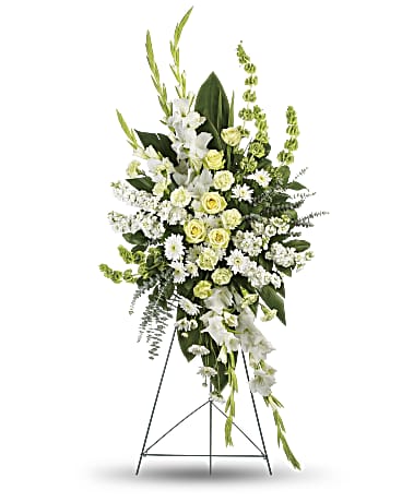 A large standing spray of all white and green assorted flowers.   Flower variety will vary depending on availability. Arrangement will be as close as possible, but may not be exact.