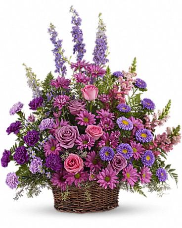 It's all about pinks, purples and lavenders with this basket arrangement. A variety of garden flowers such as larkspur, roses, daisies, carnations, snapdragons and asters.   Basket and/or flower variety will vary depending on availability. Arrangement will be as close as possible, but may not be exact. 