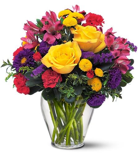 Bright hot pink, yellow and purple flowers, this arrangement is the right remedy to brighten anyone's day!  Vase and/or flower variety will vary depending on availability. Arrangement will be as close as possible, but may not be exact.