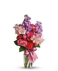 A bud vase filled with lavender stock, hot pink carnations, roses and pink alstromeria.  Vase and/or flower variety will vary depending on availability. Arrangement will be as close as possible, but may not be exact.