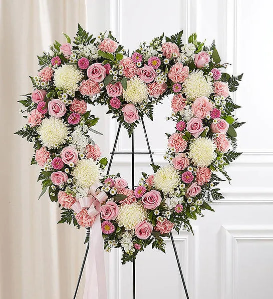 A beautiful heart shaped floral arrangement filled with a variety of seasonal white and light pink flowers. Make a statement for your loved one with this perfect piece.

Flower variety will vary depending on seasonal availability. Arrangement will be as close as possible, but may not be exact.