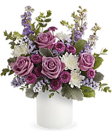 Bouquet of purple and white flowers in a white ceramic pot on a white background