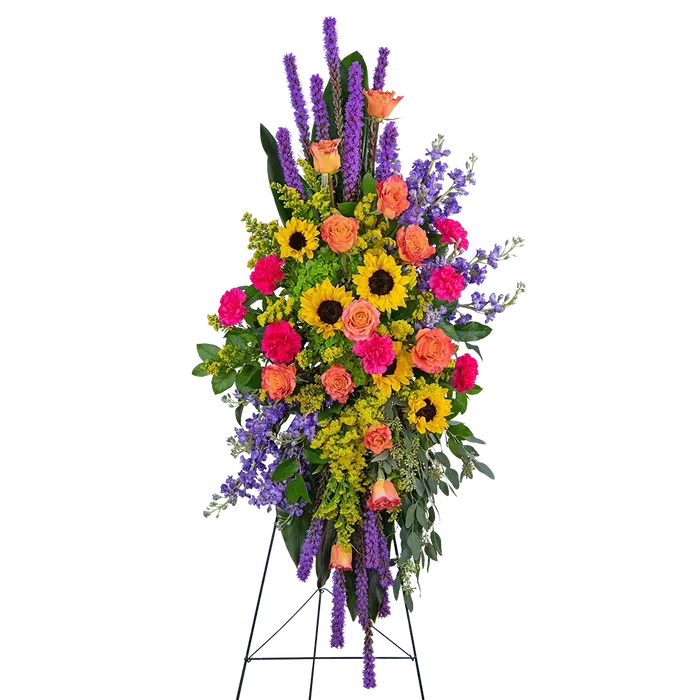 Colorful flower arrangement on a stand with sunflowers, roses, and lavender against a white background