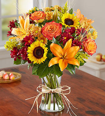 This vase is filled with all your favorites. Roses, sunflowers, lilies, daisy mums and wheat in rich fall colors make this a harvest delight.   Vase and/or flower variety will vary depending on availability. Arrangement will be as close as possible, but may not be exact.