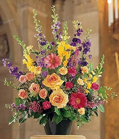 A large variety of flowers such as colorful larkspur, snapdragons, roses and carnations can be found in this plastic container.   Container and/or flower variety will vary depending on availability. Arrangement will be as close as possible, but may not be exact.