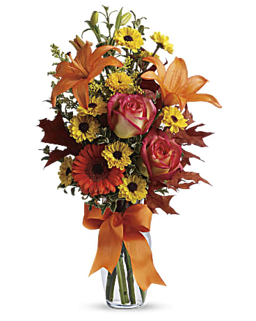 A small vase filled with beautiful Fall colored roses, lilies and daisies perfectly designed into this cute Burst of Autumn.   Vase and/or flower variety will vary depending on availability. Arrangement will be as close as possible, but may not be exact.