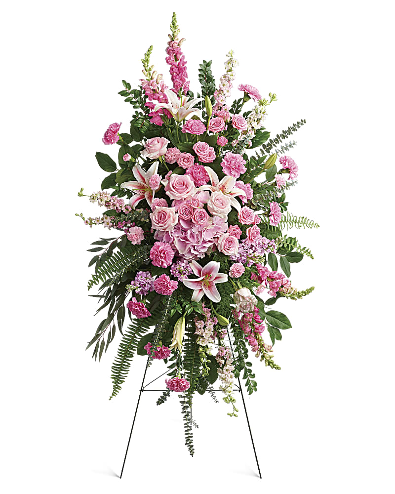 A beautiful standing spray of assorted pink flowers.  Flower variety will vary depending on availability. Arrangement will be as close as possible, but may not be exact. 