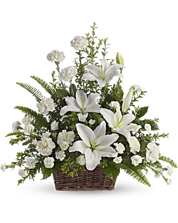 Peaceful lilies has white lilies, carnations, miniature carnations and greenery in a basket.   Basket and/or flower variety will vary depending on availability. Arrangement will be as close as possible, but may not be exact.