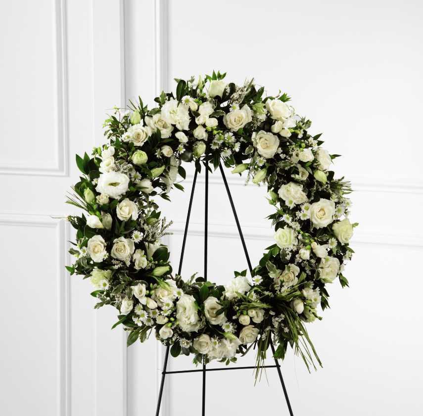 Fresh floral wreath created out of all white assorted flowers and greenery.   Flower variety will vary depending on availability. Arrangement will be as close as possible, but may not be exact.