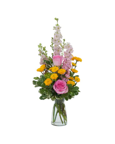 A small arrangement made with pink and yellow assorted flowers in a clear glass vase.   Vase and/or flower variety will vary based upon seasonal availability. The arrangement will be as close as possible, but may not be exact. 
